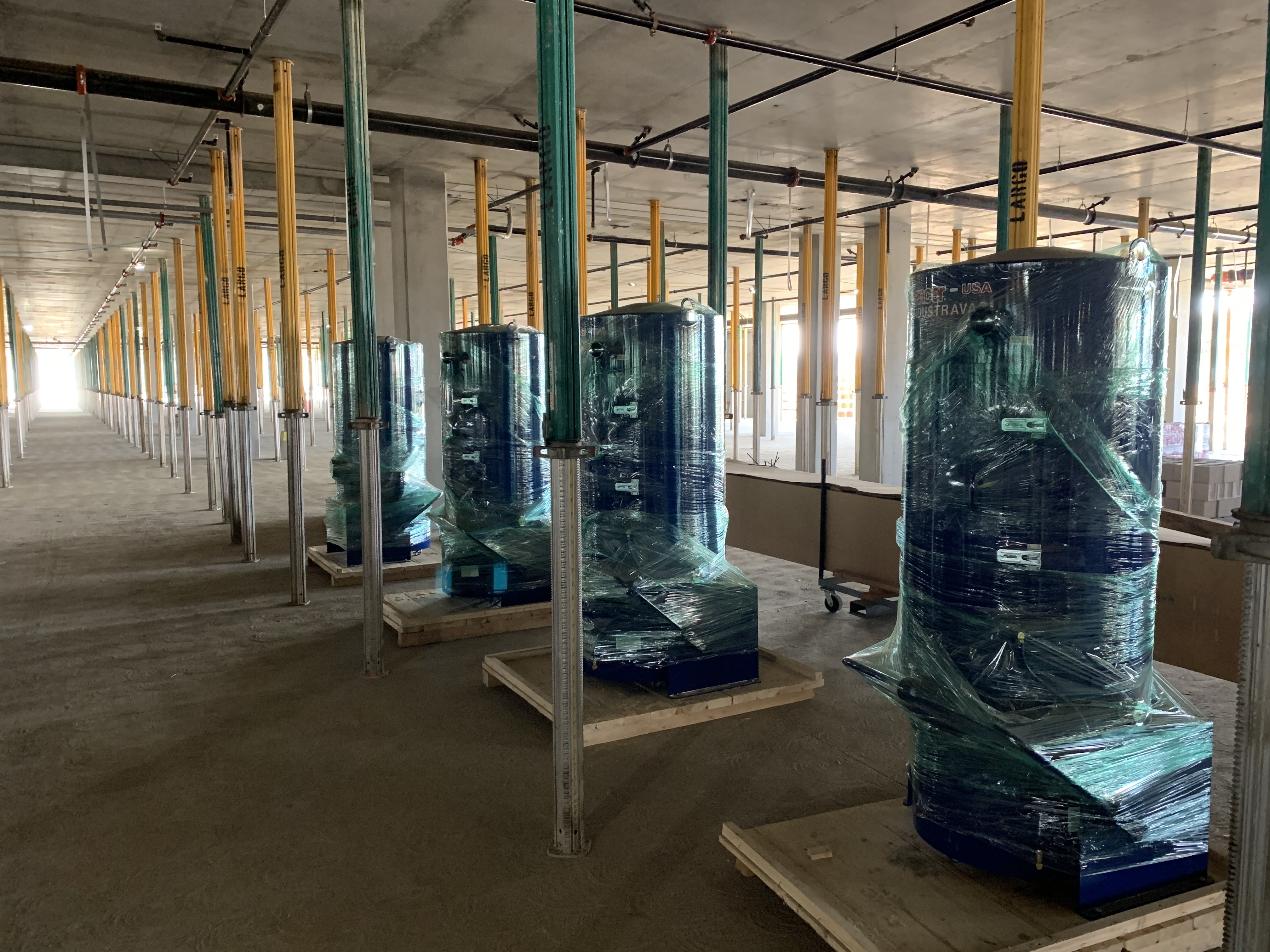 Vacuum Separators, wrapped in protective coverings prior to installation, at the Quick Turn Around (QTA) Building of the Consolidated Rent-A-Car Facility. 